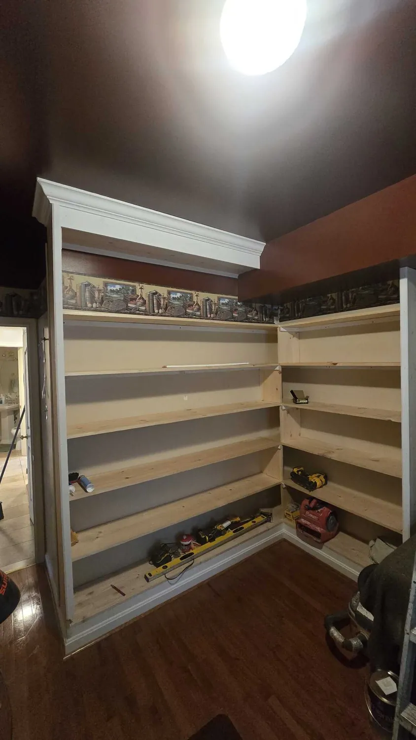 Custom built-in corner bookshelves with painted face frame and crown moulding
