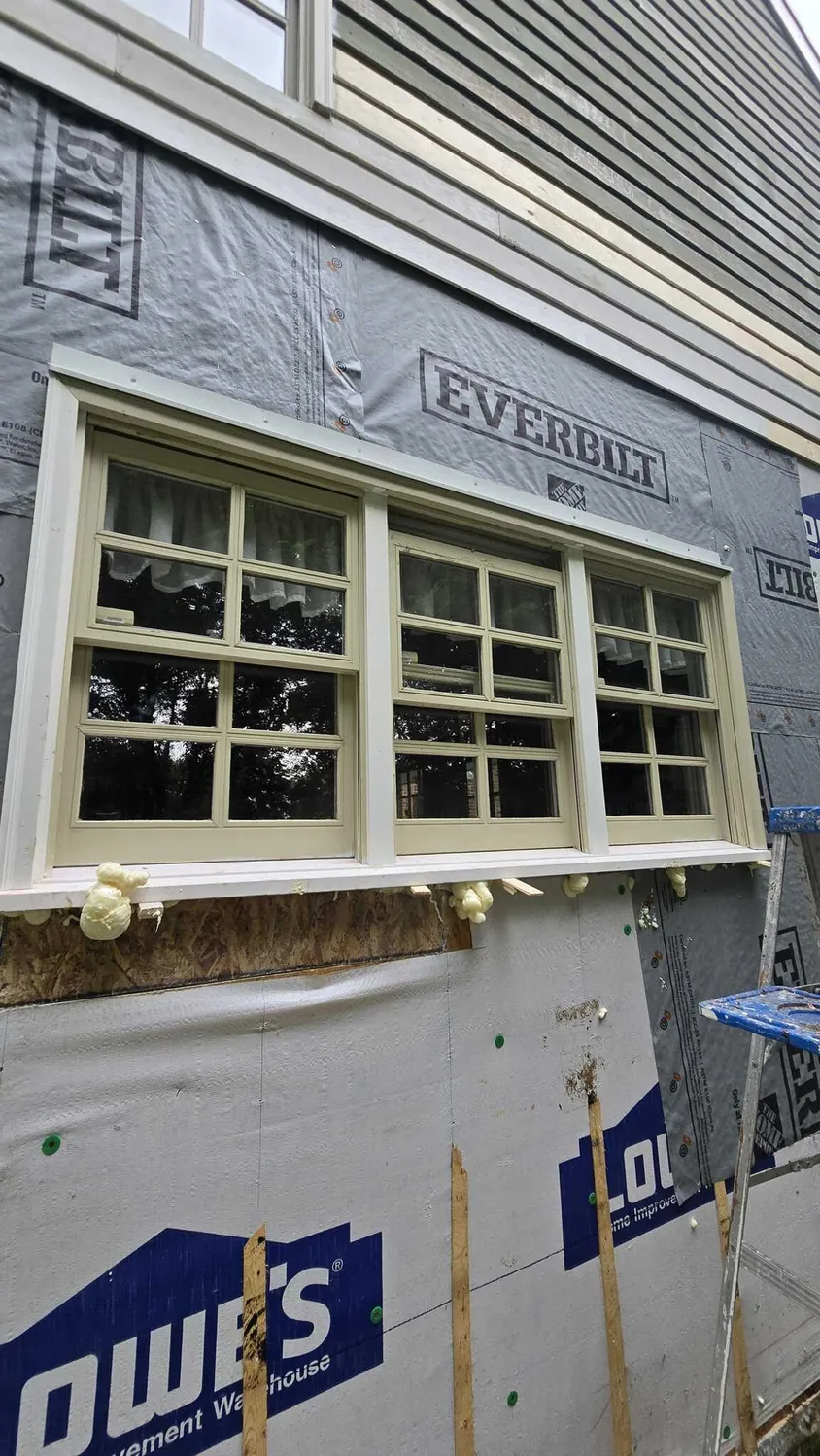 New bay window set into an exterior wall during a siding replacement
